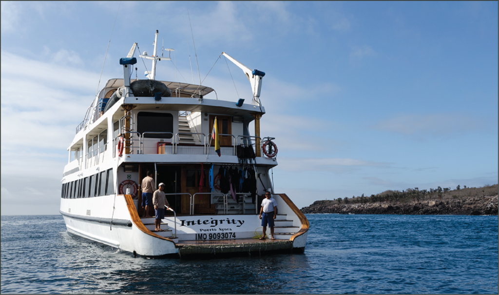 A stern view of the Integrity ship floating in the water.