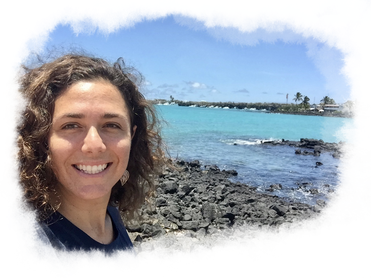 Claudia Molina, smiling by a dive site.